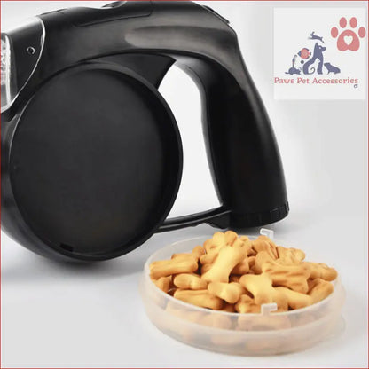 Black multifunctional retractable leash next to a bowl of dog treats for easy walks