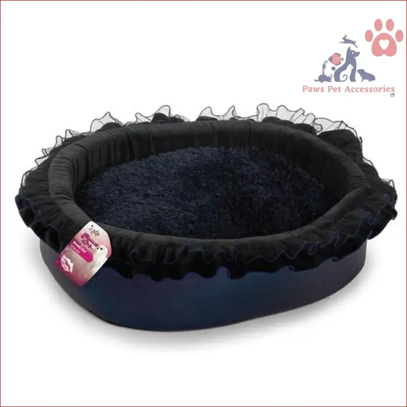 Oval-shaped Dog Dreamy Bed in Soft Night Blue with plush black lining and ruffled edges