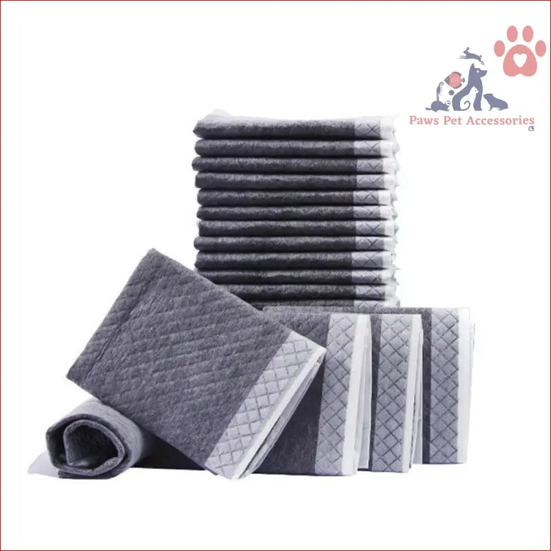 Stack of gray and white striped towels next to PETSWOL disposable dog training pads