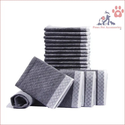 Stack of gray and white striped towels next to PETSWOL disposable dog training pads