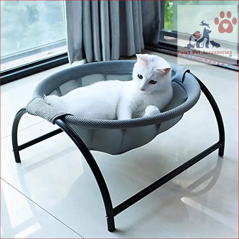 White cat relaxing in PETSWOL elevated cat bed hammock with stylish metal legs