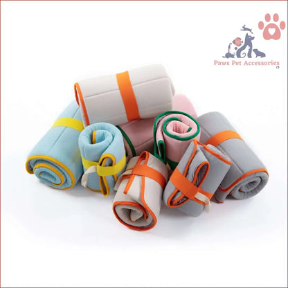 Rolled-up colorful towels perfect for the Pet Dog Cooling Mat Travel Roll