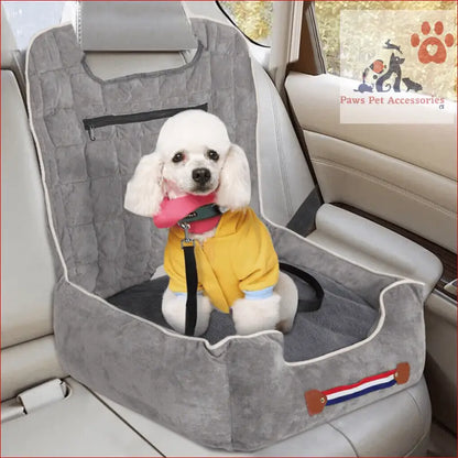 White poodle in a yellow jacket on an anti-slip pet booster seat with safety leash