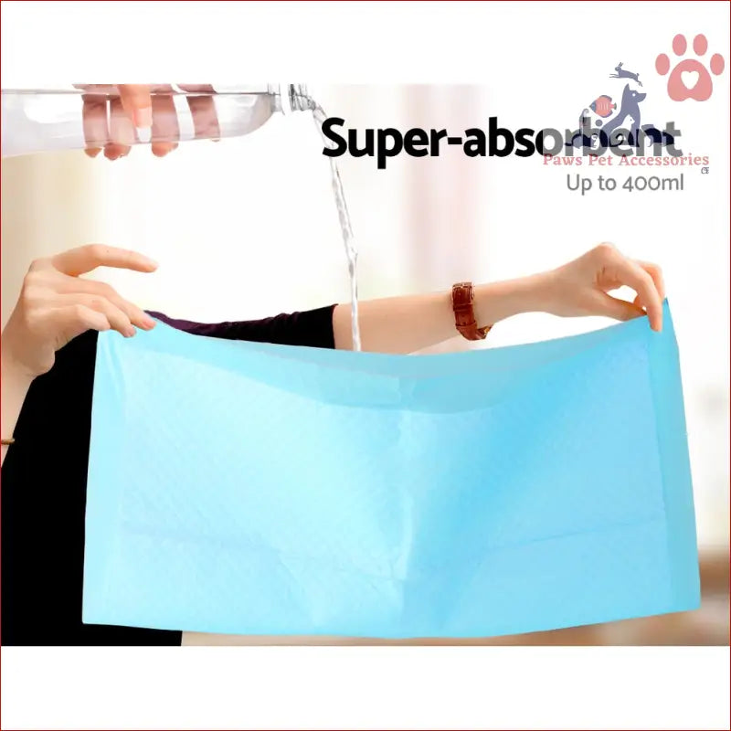 Light blue super absorbent pet training pads being tested with liquid for optimal performance