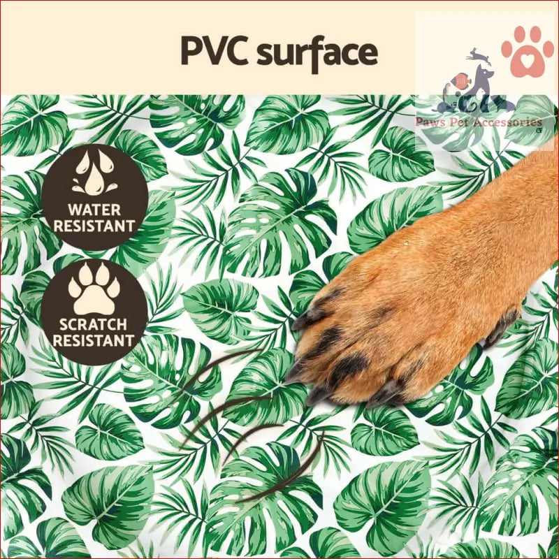 Dog paw with brown fur and black nails on a Pet Cooling Mat with tropical leaves