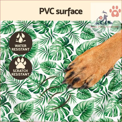 Dog paw with brown fur and black nails on a Pet Cooling Mat with tropical leaves