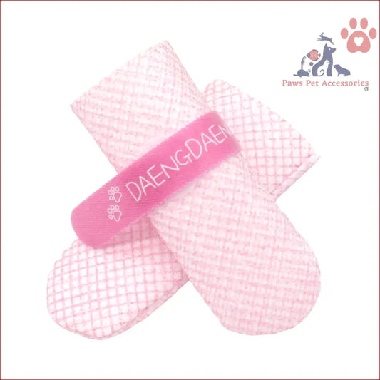 Pink hair clip with mesh texture and DAENGDAE text next to dog shoes waterproof set