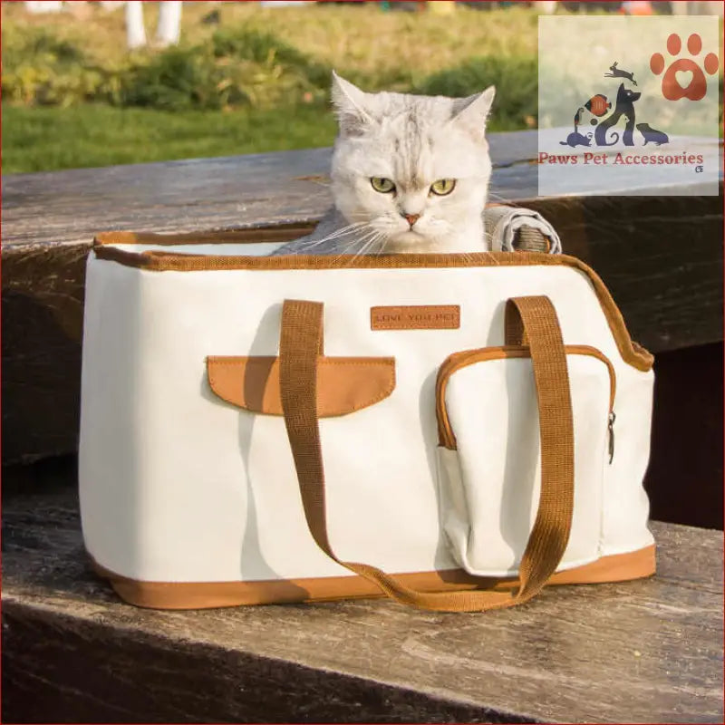 White cat peeking out of a Toast Large Capacity Cat Carrier Bag for travel