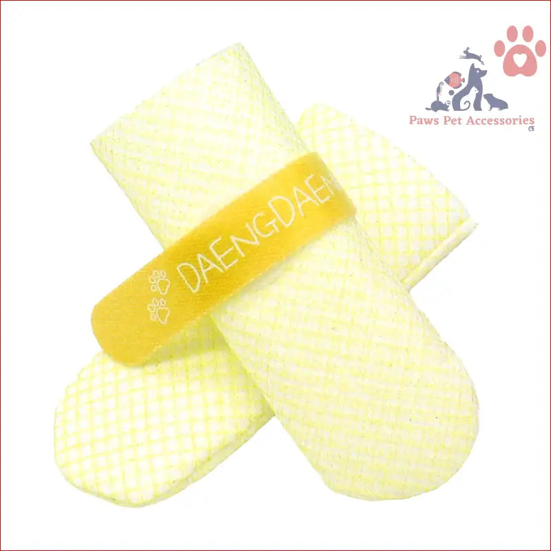 Cute yellow and white baby mittens with DAENGDAE text beside dog shoes waterproof